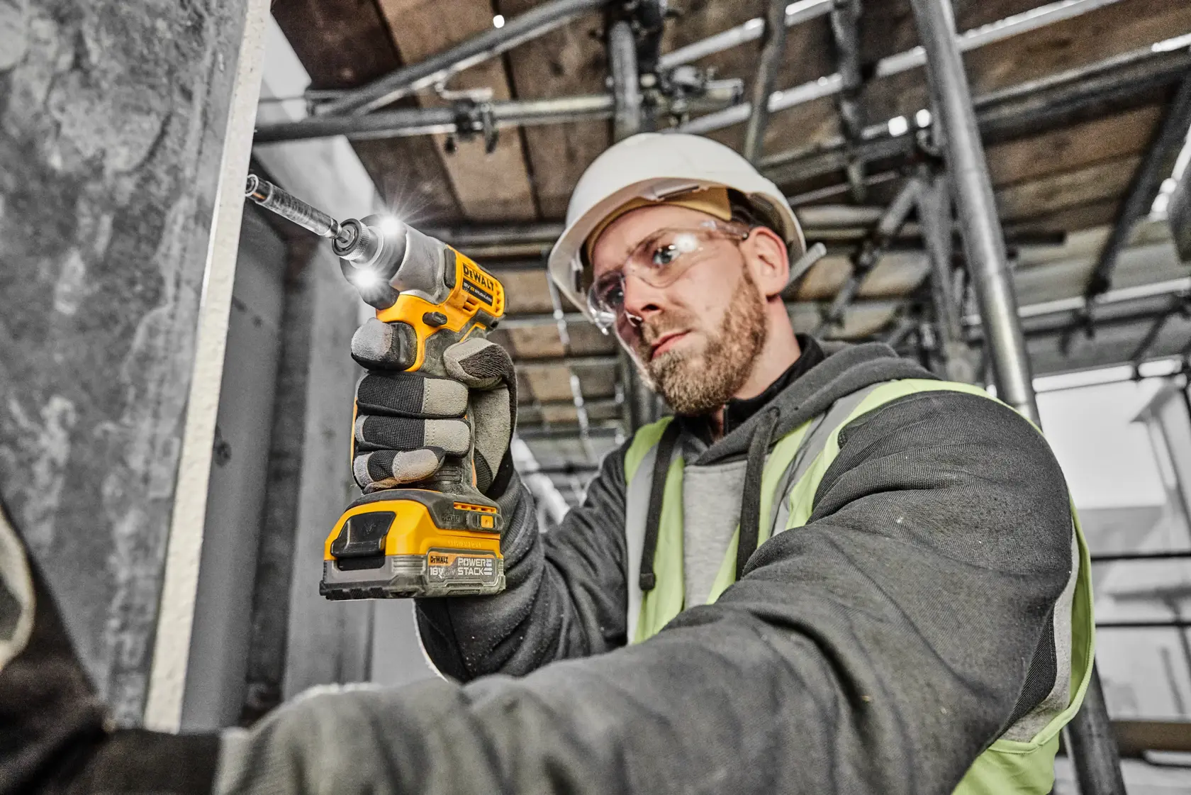 DEWALT DCF840E1T cordless impact driver with yellow and black design, one compact Powerstack battery (DCBP034), and a sturdy TSTAK case with DEWALT logo. The product is displayed with included accessories.