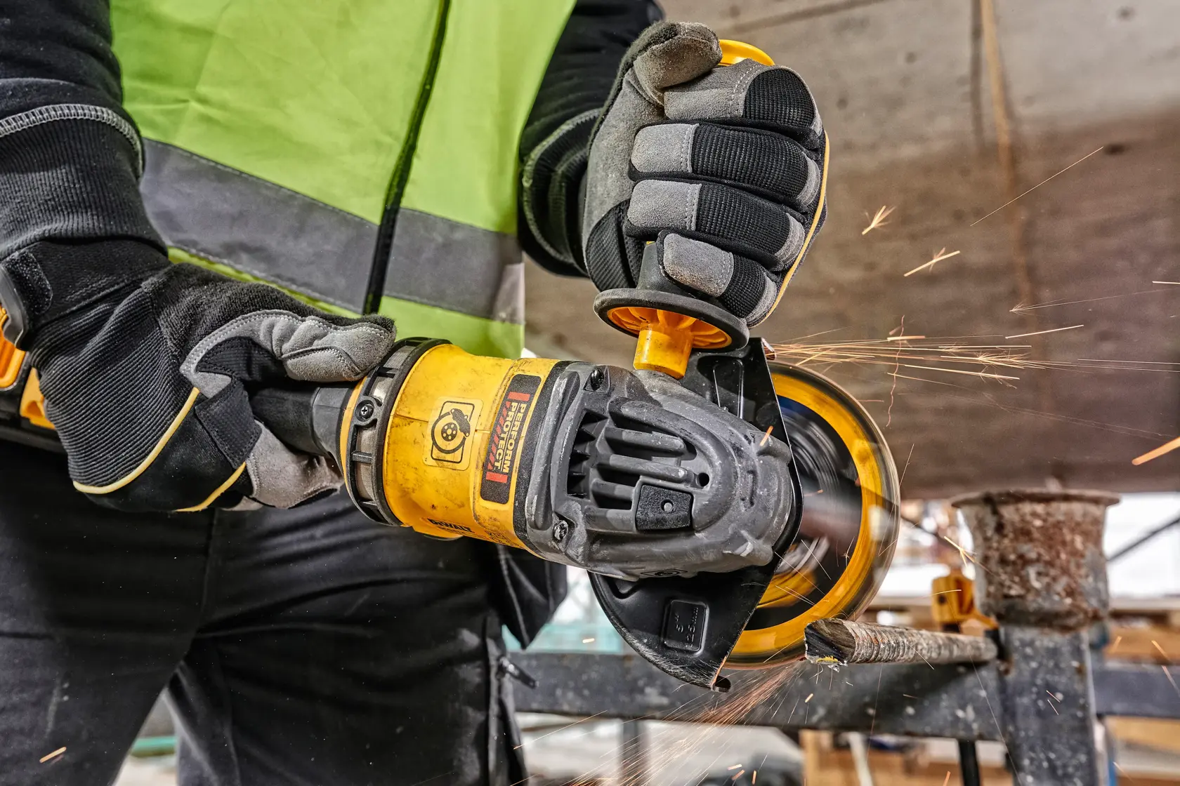 DEWALT tools in use with sparks. Shown: DCZ507T2-XE, DCG418N, DCZ503X2-XE. Photography category, ASIA EMEAANZ.
