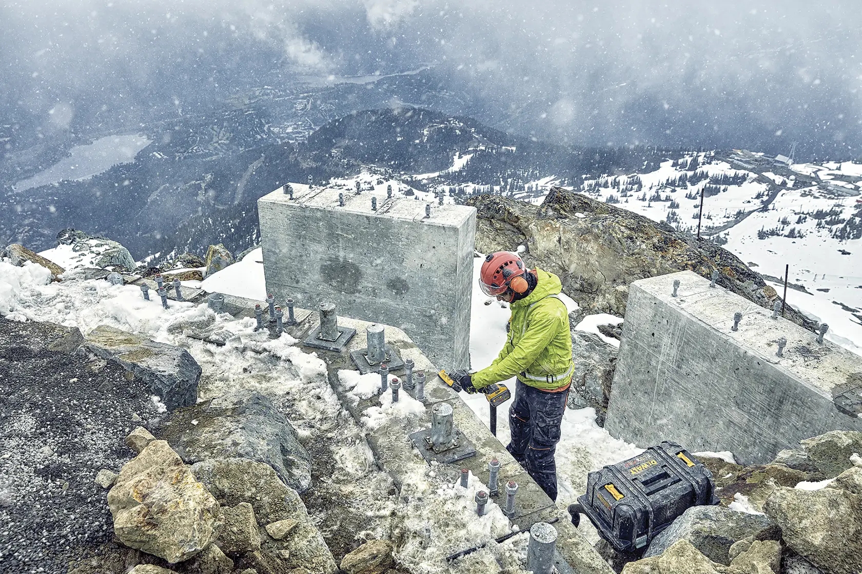 DEWALT DCZ507T2-XE, DCG418N, DCZ503X2-XE used outdoors in snowy mountain construction. Photography product image.