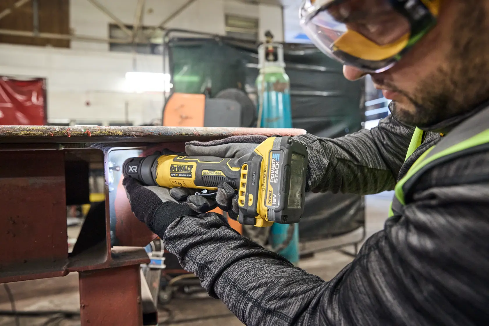 DEWALT DCG420N-XJ, DCG420N grinder used in workshop. Worker in gloves operates tool. Photography category.