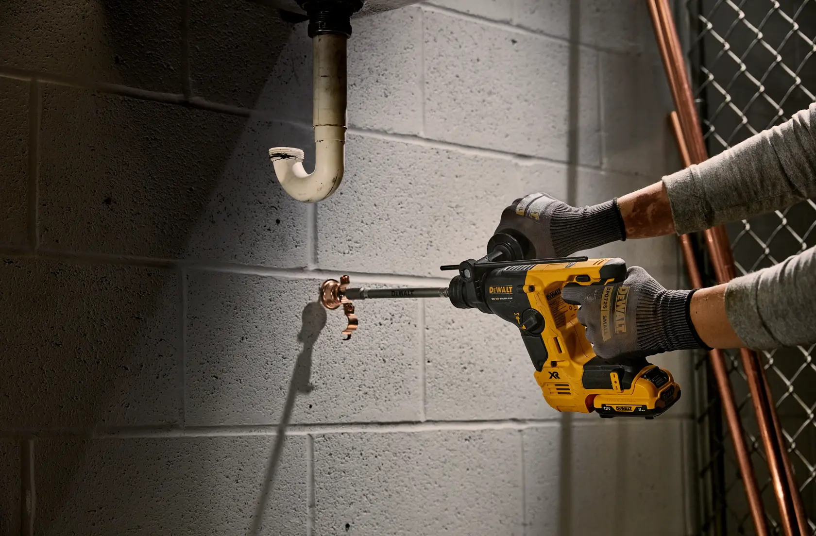 DEWALT cordless rotary hammer drill kit with a black and yellow carrying case, two batteries, and a charging station.