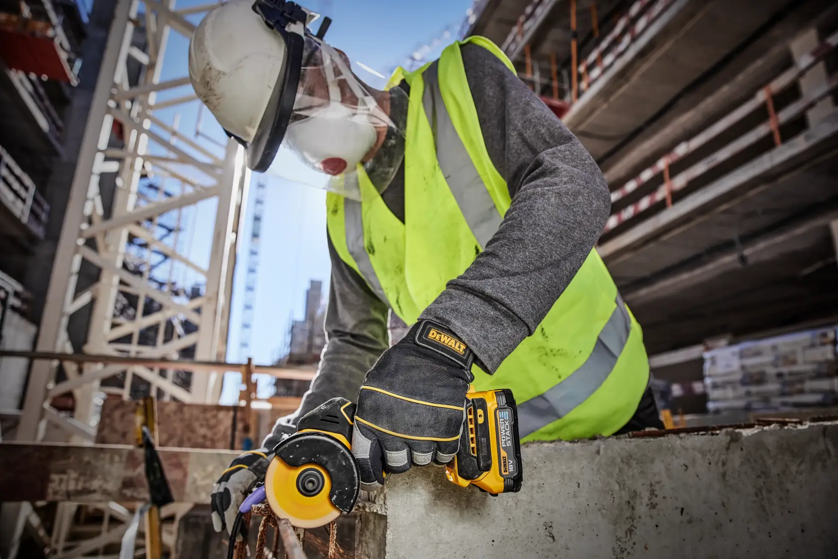 DEWALT DCS438E2T kit containing a compact power tool, two Powerstack batteries, a charger, a removable dust cover, and a TSTAK case. All items are arranged in front of a black and yellow DEWALT branded carrying case.