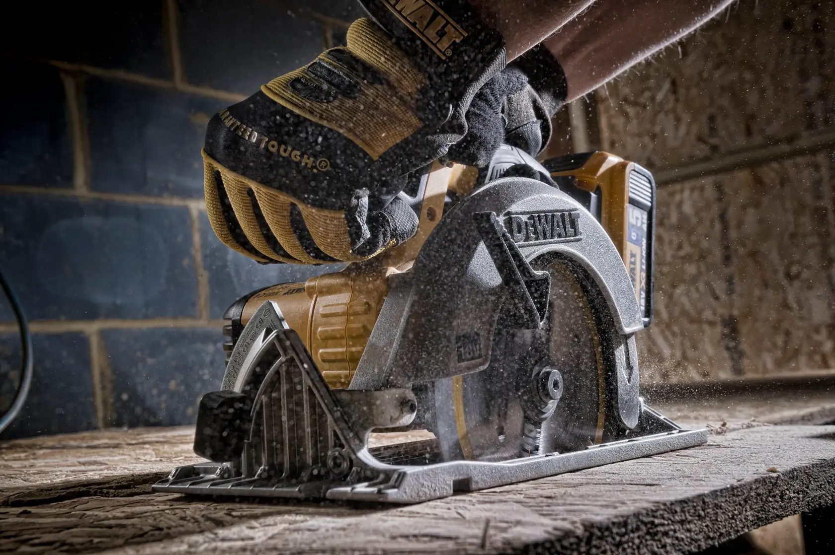 DEWALT circular saw cutting wood, operated by a person wearing safety gloves in a workshop.